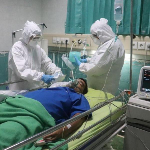 two healthcare providers with covid hospital patient