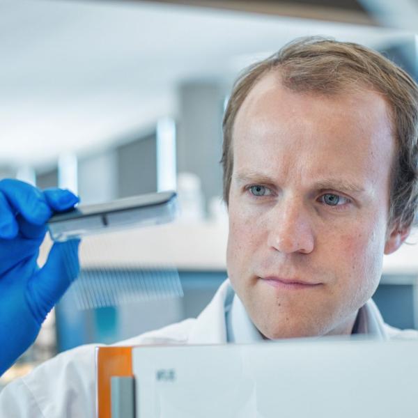 Dr. Haakon Nygaard looking at equipment he is holding