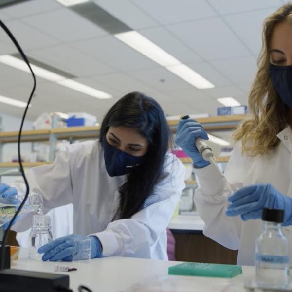 Dr. Nika Shakiba abd colleague in SBME lab coat working in a wet lab