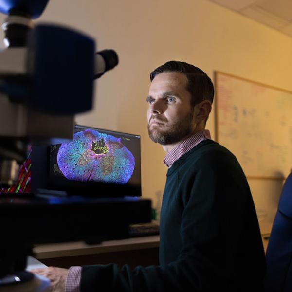 researcher in front of imaging instruments